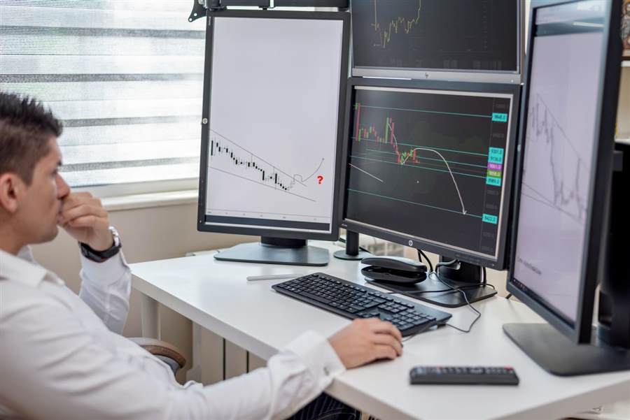 IT professional monitoring multiple screens for system health