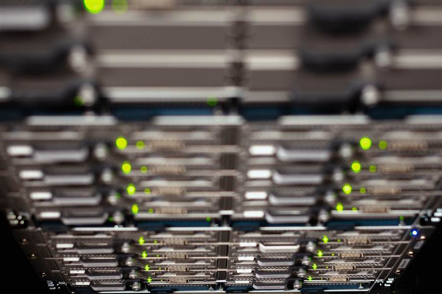 Technician installing network hardware in a server rack
