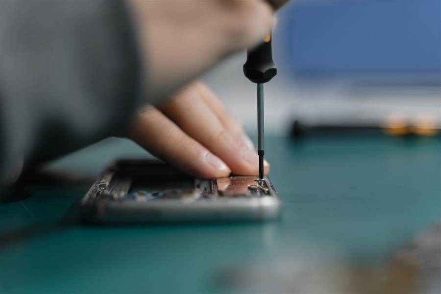 Technician repairing hardware in a workshop