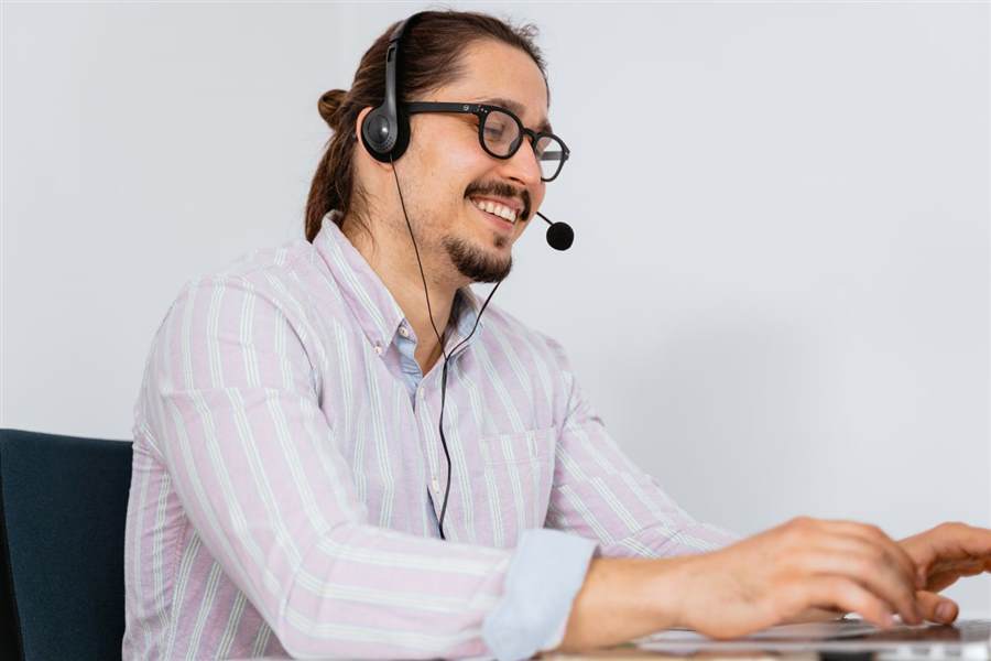 IT support technician on a headset assisting a client
